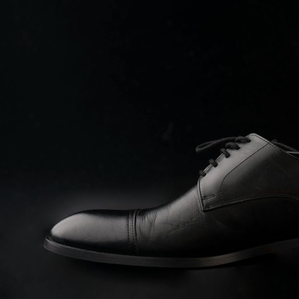 Pair of leather oxfords on a marble plinth